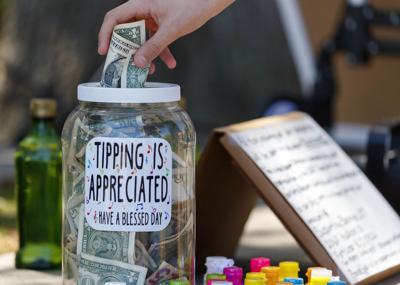 The Palmetto Rose Band collects donations to help Ukraine while they play at Waterfront Park on April 3, 2022.