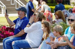 Spectators cheer as they listen to the Palmetto Rose Band at Warfront Park while collecting donations to help Ukraine on April 3, 2022
